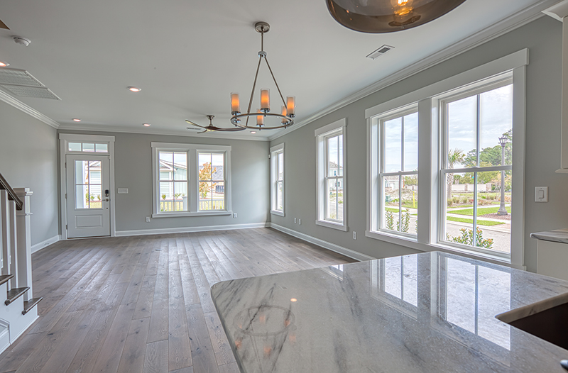 Wood floors windows living to kitchen