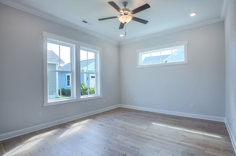 Big windows in vacant room with fan