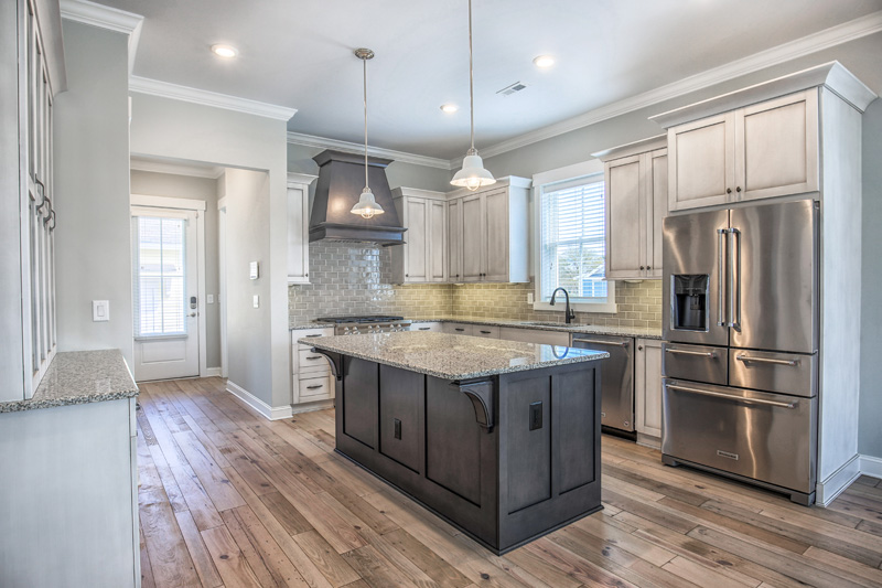 Open kitchen with seating and hallway leading to outdoors