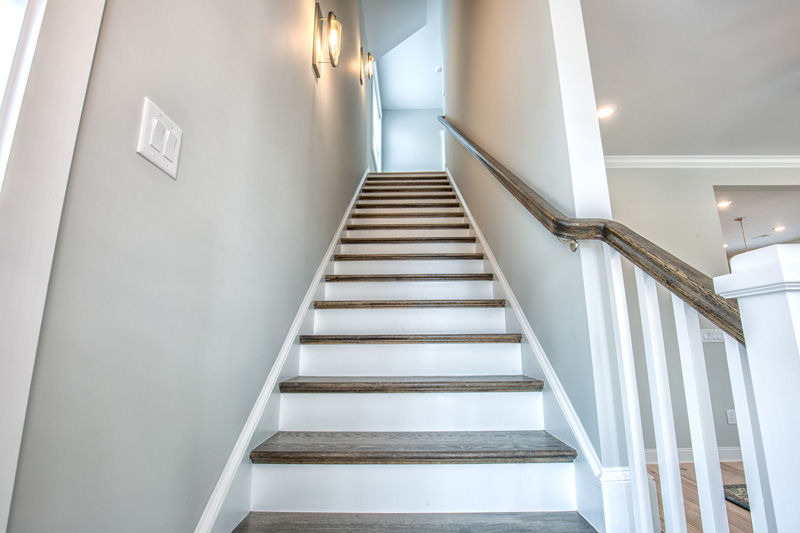 Looking up a staircase with white and wood