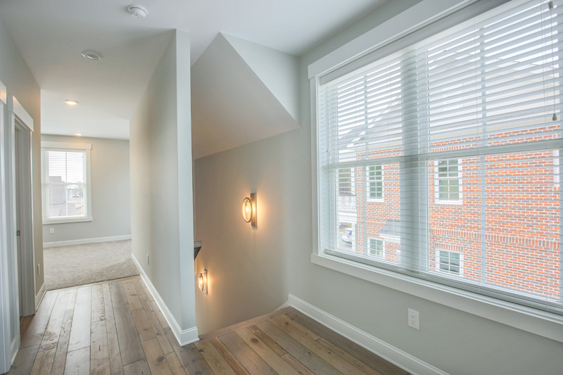 Upstairs wood hallway to open living space