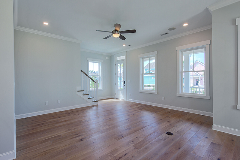 Open living room with wood floors and windows